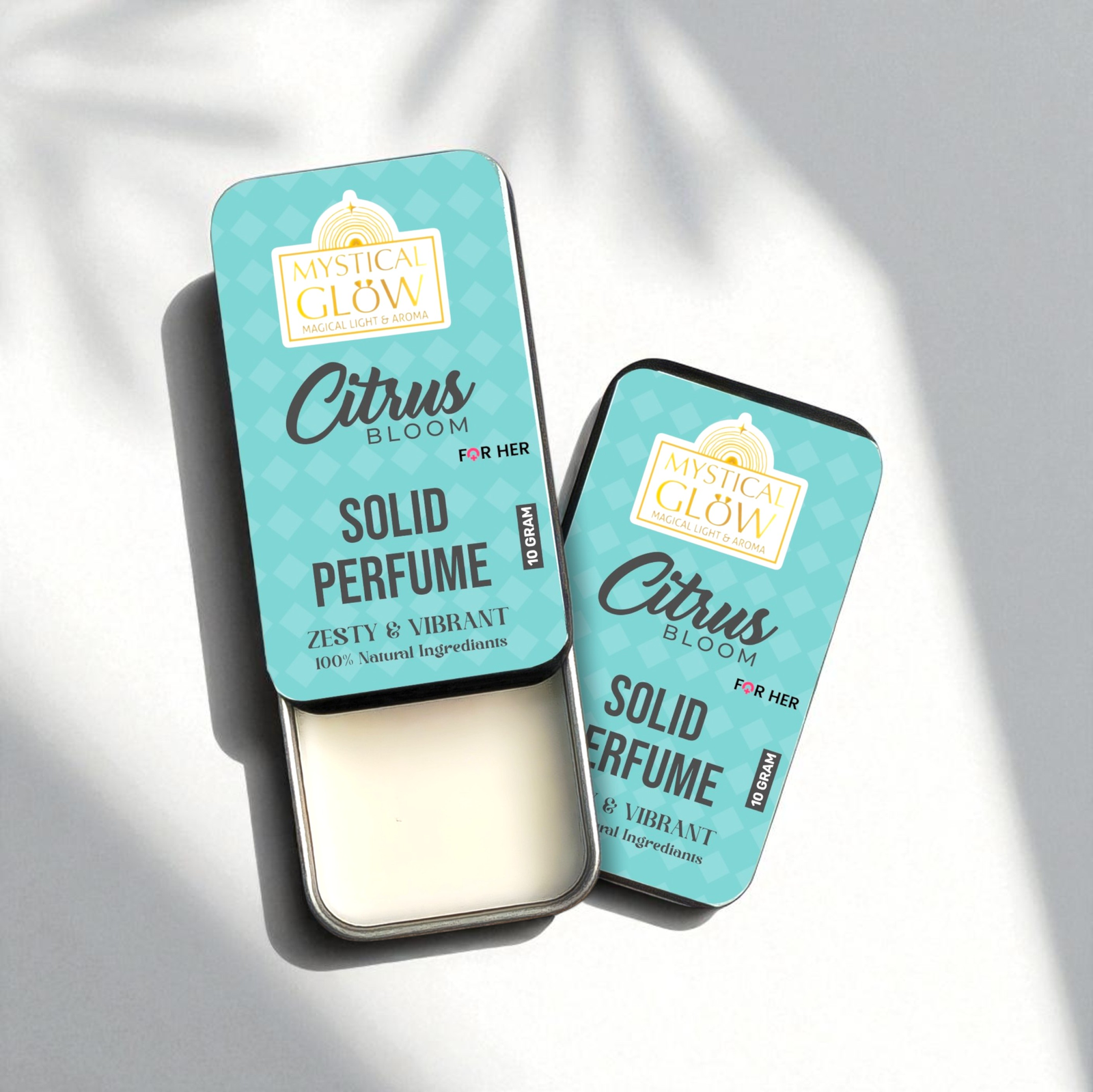 Citrus Bloom Solid Perfume for women tin placed with fresh lemons, oranges, and white blossoms on a clean white background.