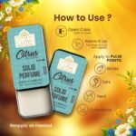 Woman applying Citrus Bloom solid perfume on neck and wrist from compact tin.