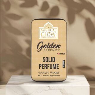 A Luxurious Solid Perfume – Golden Serenity Blends Saffron, Oudh & Sandalwood Golden Serenity solid perfume tin displayed aesthetically on a rustic wooden platform with soft ambient light.