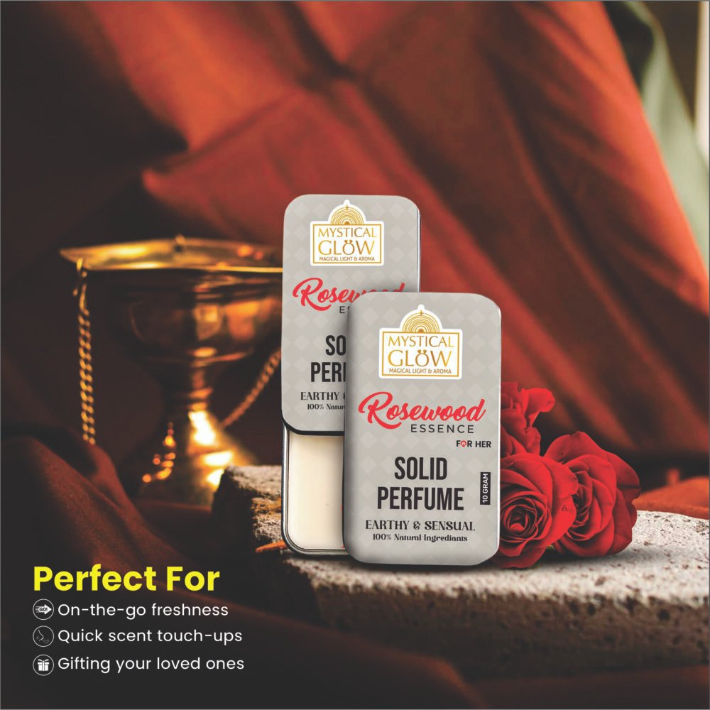 Woman applying Rosewood Essence solid perfume to wrist, showcasing alcohol-free and skin-friendly application.