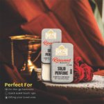 Woman applying Rosewood Essence solid perfume to wrist, showcasing alcohol-free and skin-friendly application.