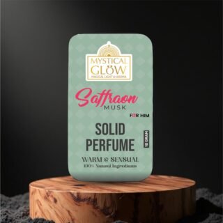Saffron Musk – A Sensual Blend of Grace, Luxury & Serenity in a Balm Flat lay of Saffron Musk Solid Perfume with men’s accessories like watch, leather wallet, and cufflinks – showcasing it as a luxury grooming essential.